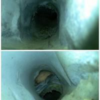 A look inside a dryer vent line that has some debris collected and some damage that encourages the collection of lint.